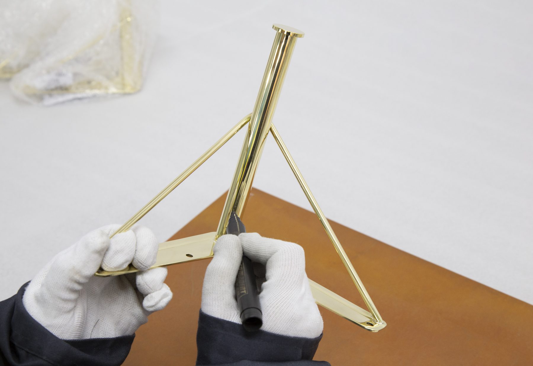 Inspecting a polished brass assembly by hand